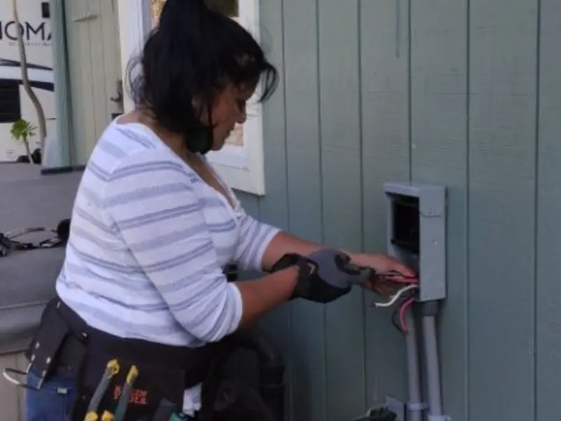 Licensed electrician wiring an exterior subpanel in Tupper Lake